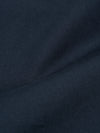 Close-up of the Navy Twill Fatigue Pant fabric. The twill weave is visible, showing the texture and color of the material. The pants are folded on a plain surface.
