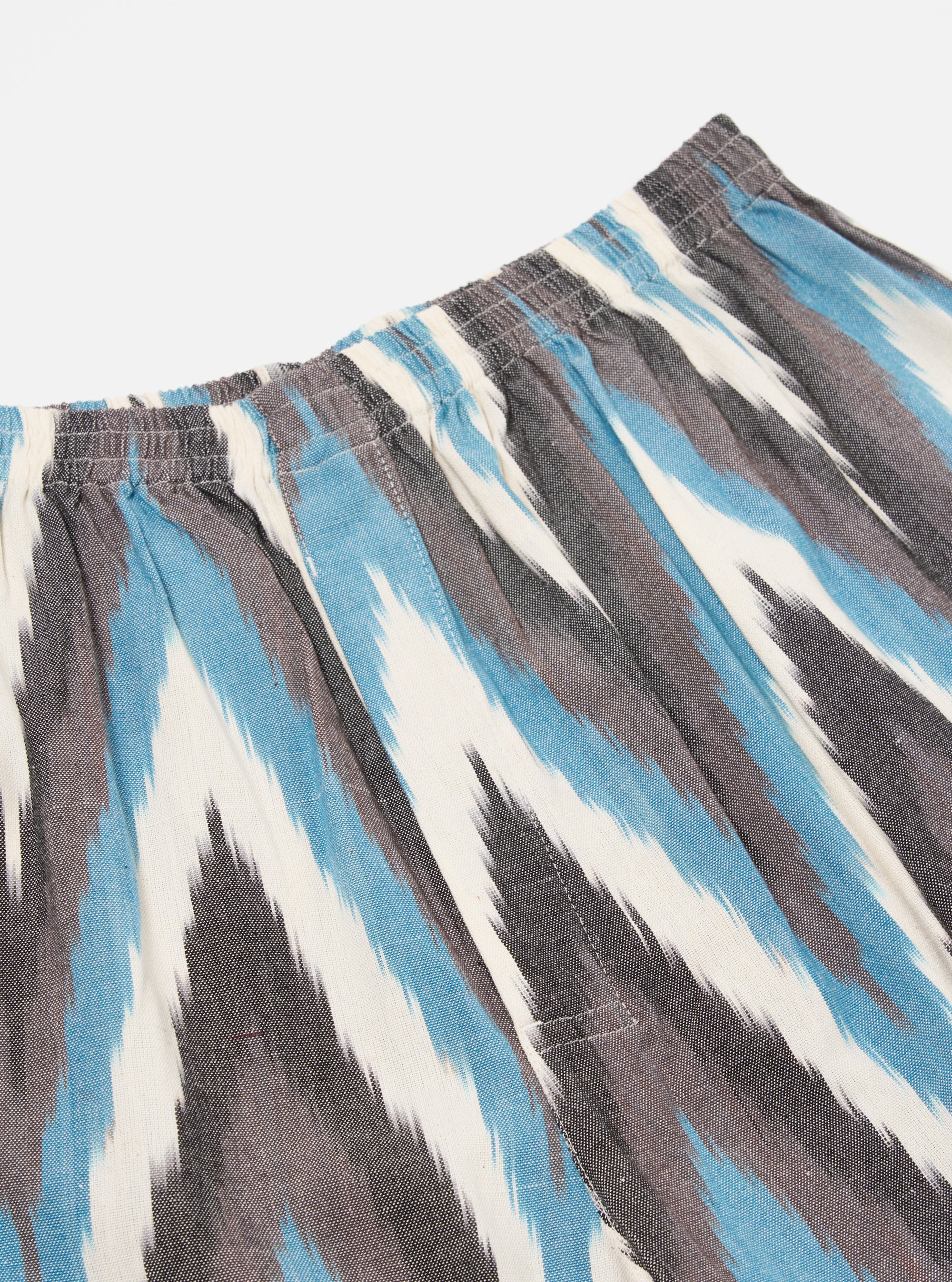 Close-up of Ecru Ikat II Cotton Boxer Short on a white background. The shorts feature a blue, gray, and white ikat pattern and an elastic waistband.