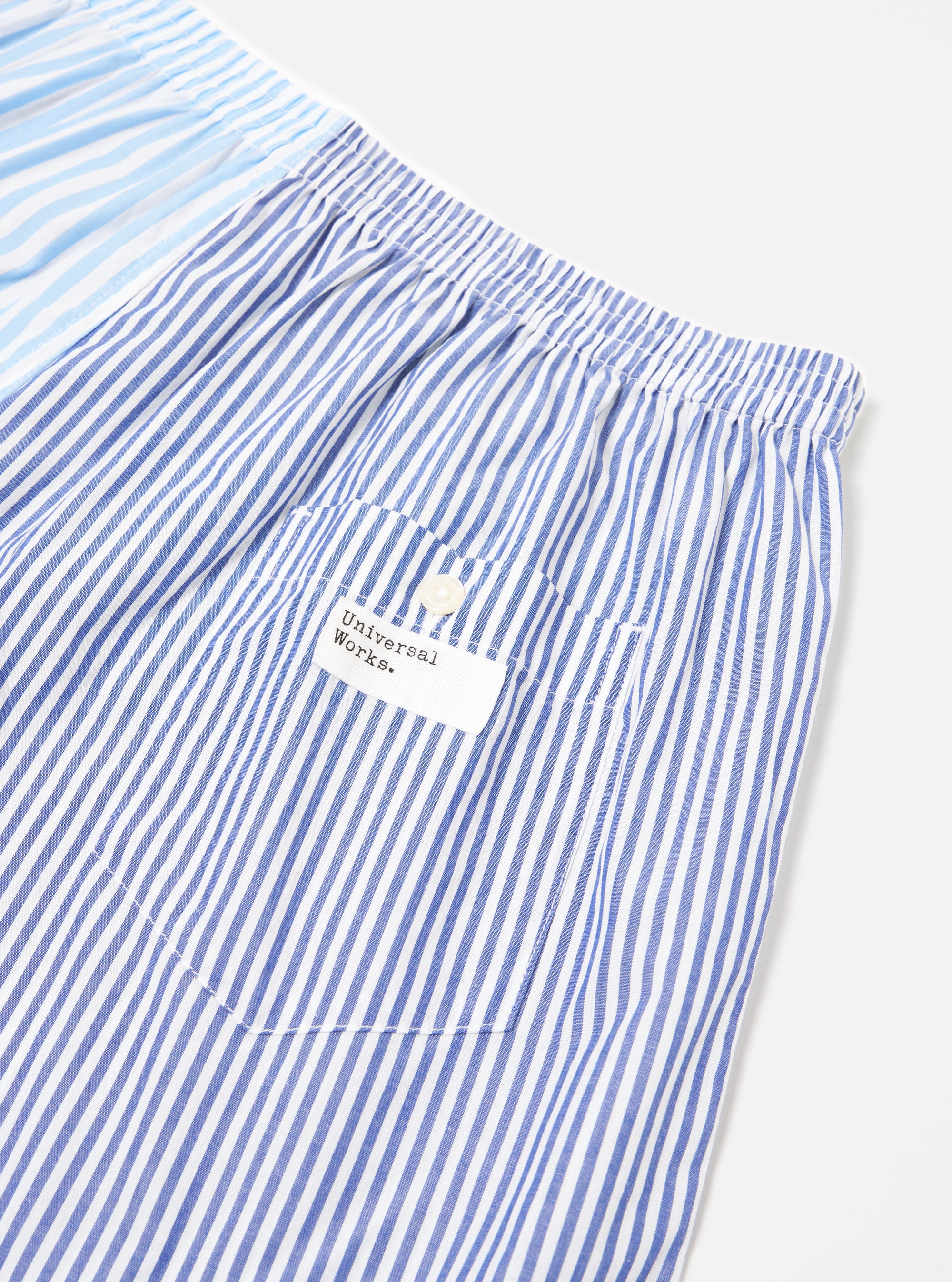 Close-up of the Blue Classic Mix Boxer Short on a white background. Features blue and white stripes, an elastic waistband, and a small pocket with a button.
