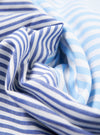 Close-up of the Blue Classic Mix Boxer Short fabric. Features blue and white stripes in a soft cotton blend. The material is artfully draped to showcase its texture.