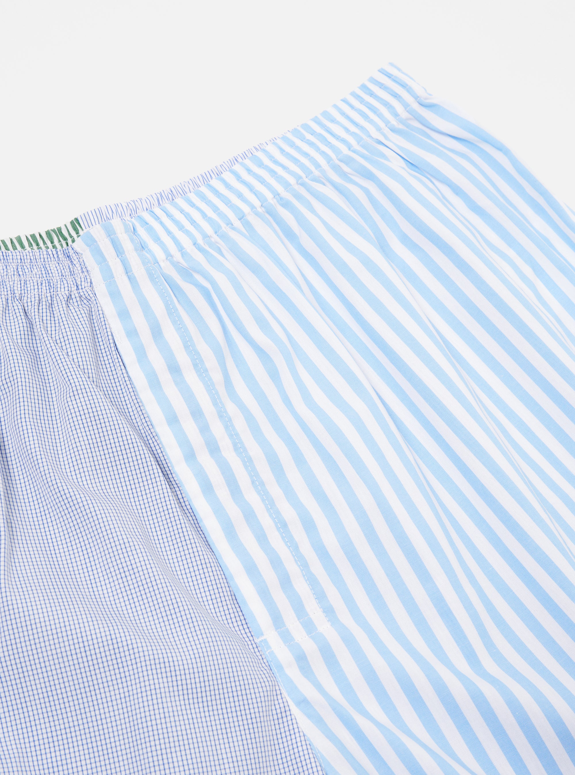 Close-up of the Blue Classic Mix Boxer Short on a white background. Features blue stripes and a blue grid pattern. The elastic waistband is visible.