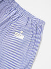 Close-up of the Blue Classic Mix Boxer Short on a white surface. The blue and white striped cotton boxer shorts feature an elastic waistband and a small pocket with a button.