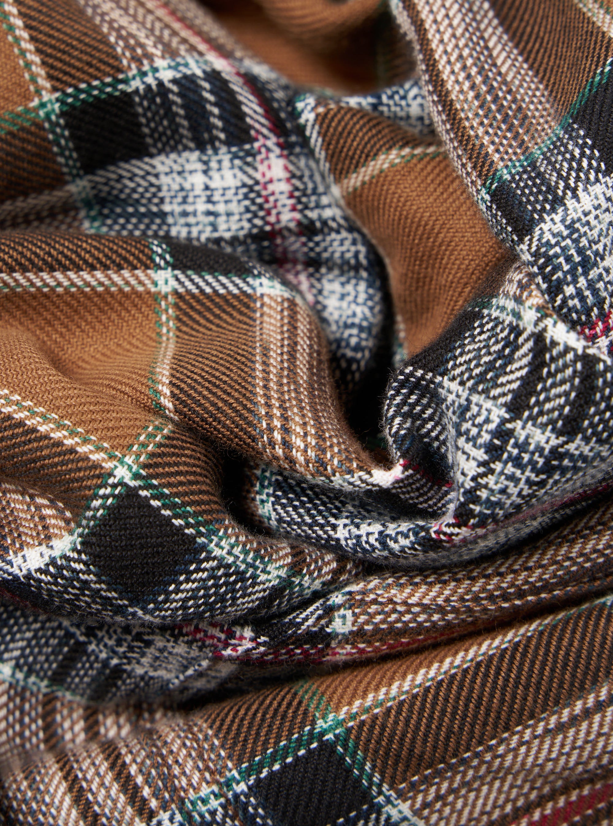 Close-up of the Brown Ikat Twill Check Long Pyjama Set fabric. The brown, black, and white twill check pattern is displayed in a folded arrangement.