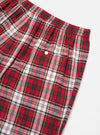 Close-up of the Red Madras Check Short Pyjama Set. The red, white, and green plaid shorts are on a white surface. Elastic waist and pocket detail are visible.