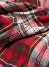 Close-up of the Red Madras Check Short Pyjama Set fabric. Features a red, white, and green plaid pattern. The material is soft and textured.