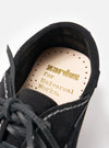 Close-up of the Zardus for Universal Works Black Suede Oliver shoe on a white background, showing the insole with gold lettering.