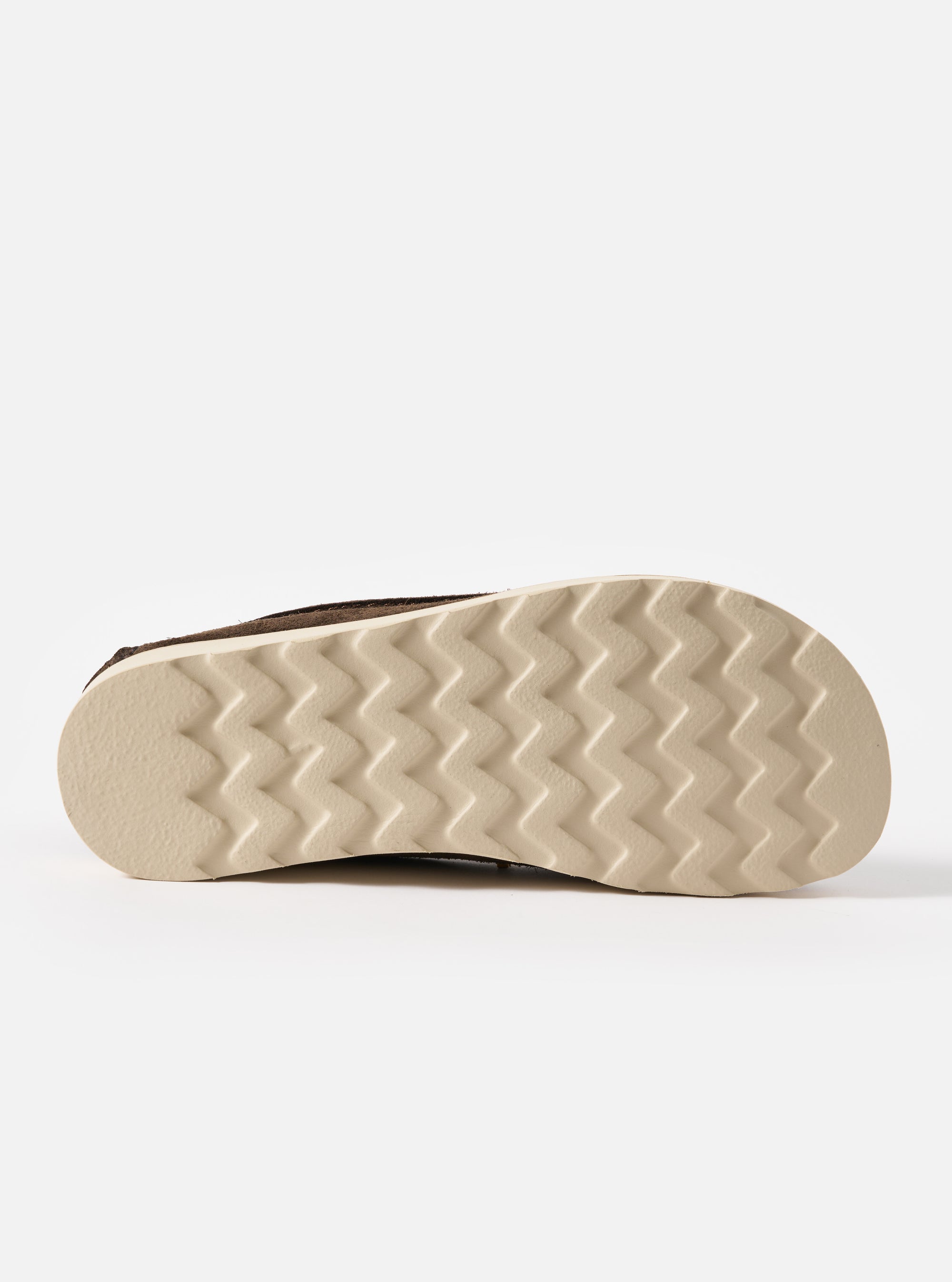 Close-up of the sole of the Zardus for Universal Works Dark Brown Suede Jack. The sole is a light tan color with a zig-zag pattern. The background is a plain white.