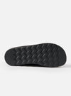 Close-up of the sole of the Zardus for Universal Works Black Suede Oliver sandal. The black rubber sole has a zig-zag pattern. Shot on a white background.