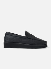 Side view of the Zardus for Universal Works Black Leather Reggie Loafer on a white background. The shoe is made of textured black leather with a chunky sole.