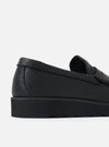 Close-up of a Zardus for Universal Works Black Leather Reggie Loafer on a white surface. The shoe features black leather and a chunky black sole.