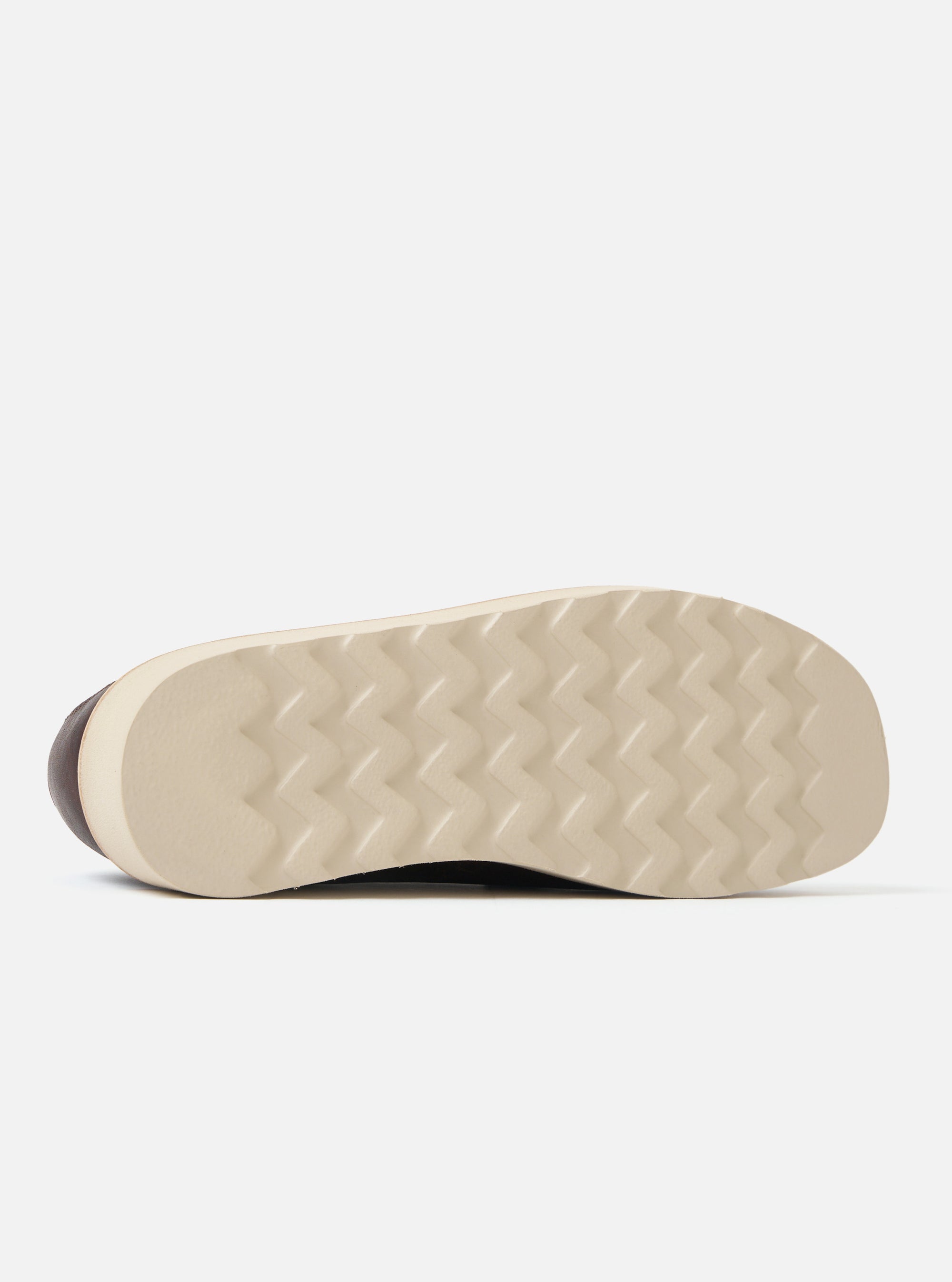 Close-up of the sole of a Zardus for Universal Works Brown Leather Reggie Loafer. The sole is a light tan color with a zig-zag pattern. Shot on a white background.
