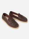 Studio shot of Zardus for Universal Works Brown Leather Reggie Loafer. The brown leather shoes have a white sole and are on a white background.