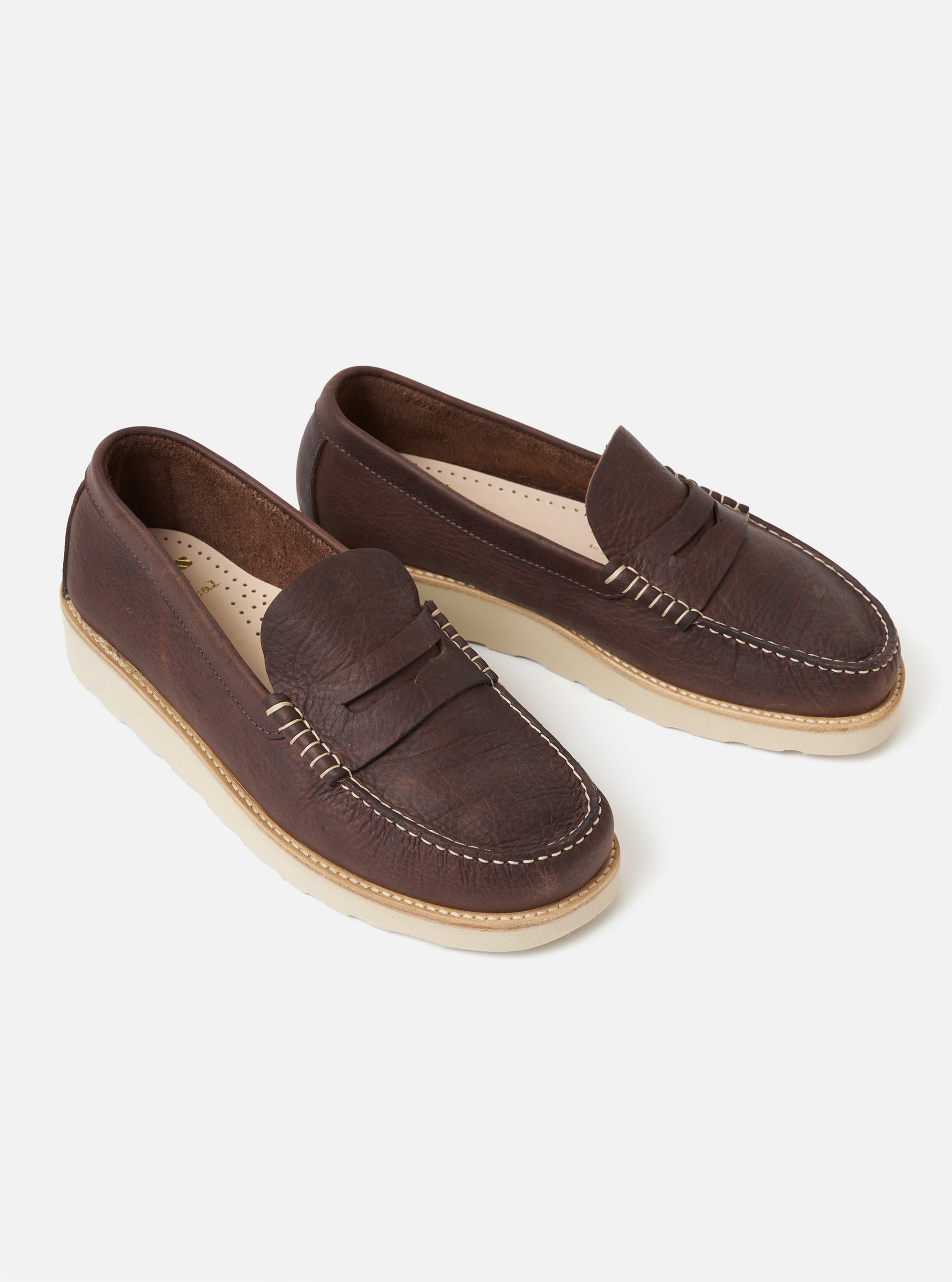 Studio shot of Zardus for Universal Works Brown Leather Reggie Loafer. The brown leather shoes have a white sole and are on a white background.