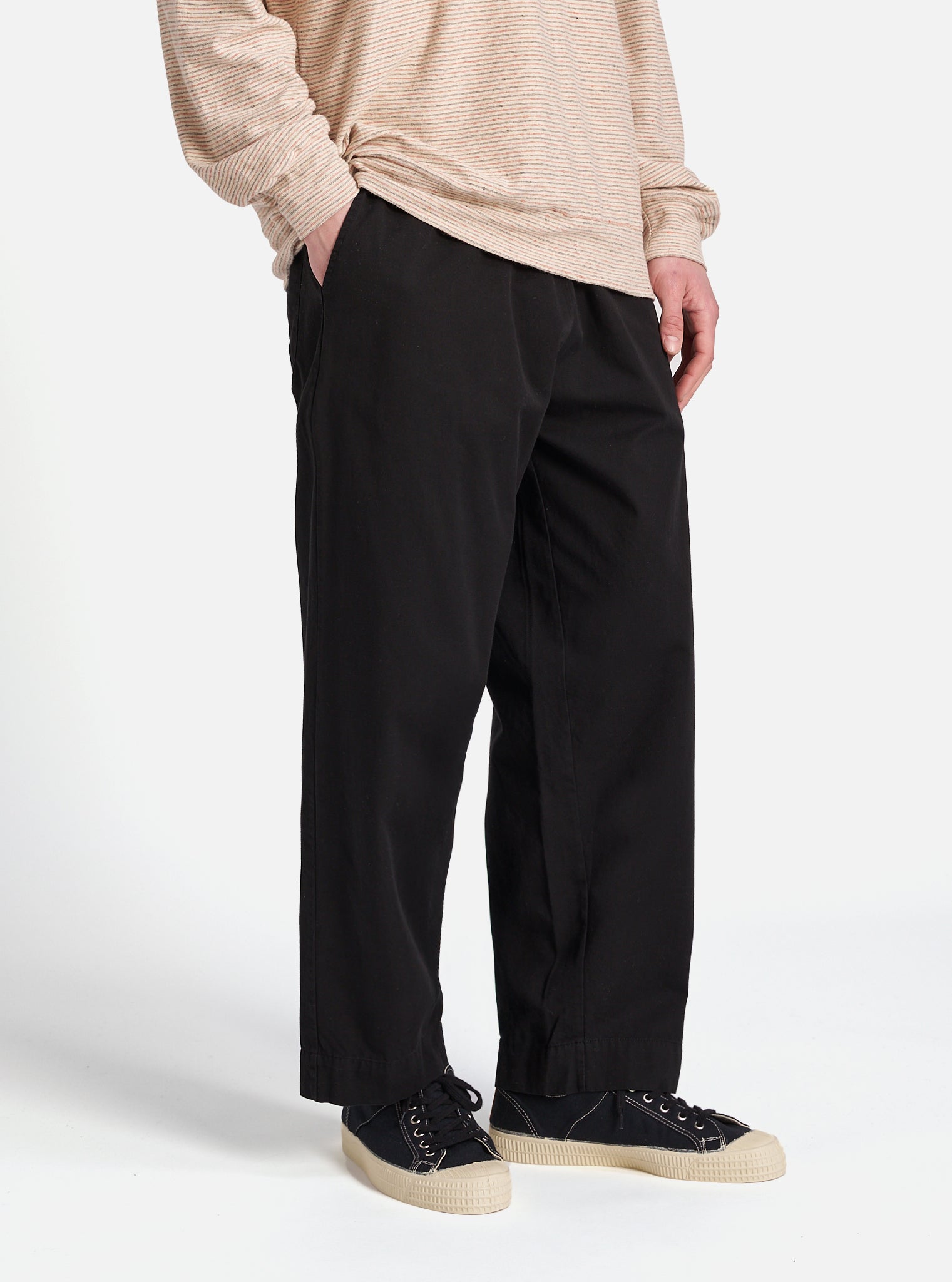 The Black Kelly Cotton Judo Pant is shown as a flat lay against a plain white background. The trousers feature a wide, straight-leg silhouette with an elasticated waistband and a tonal drawstring. Two front patch pockets are visible, and the heavy-duty cotton fabric has a matte black finish.