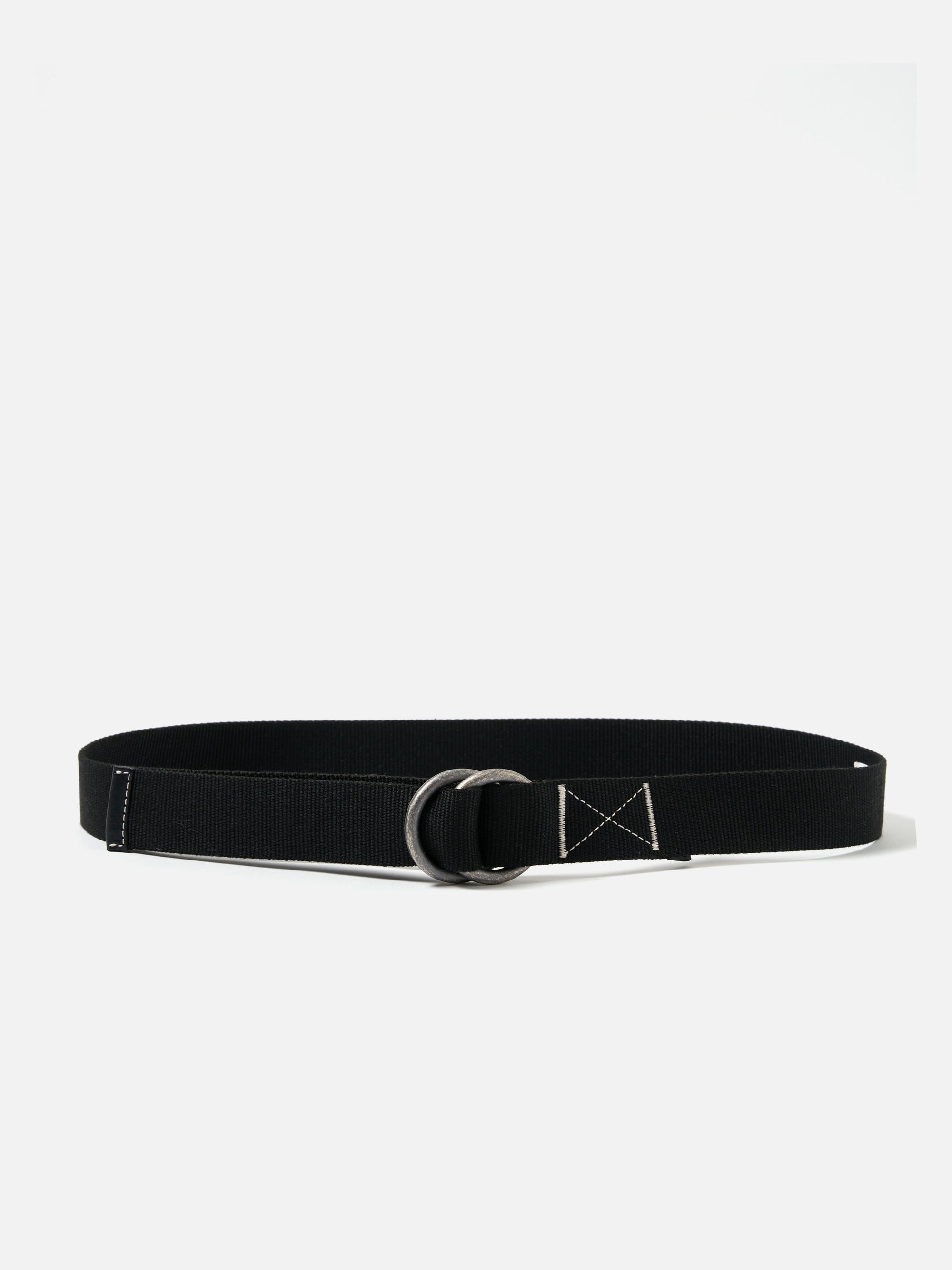 The Black Canvas O Ring Belt is displayed on a white background. The belt is black canvas with a silver O ring. Stitching details are visible.