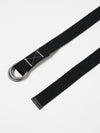 Close-up of a Black Canvas O Ring Belt on a white surface. The belt is made of black canvas with silver O-rings. The end of the belt has a black leather finish.