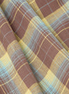 Close-up of Multi Check 3 Pack Boxer Short fabric. Brown, yellow, and blue plaid pattern. Soft cotton material, folded on a flat surface.