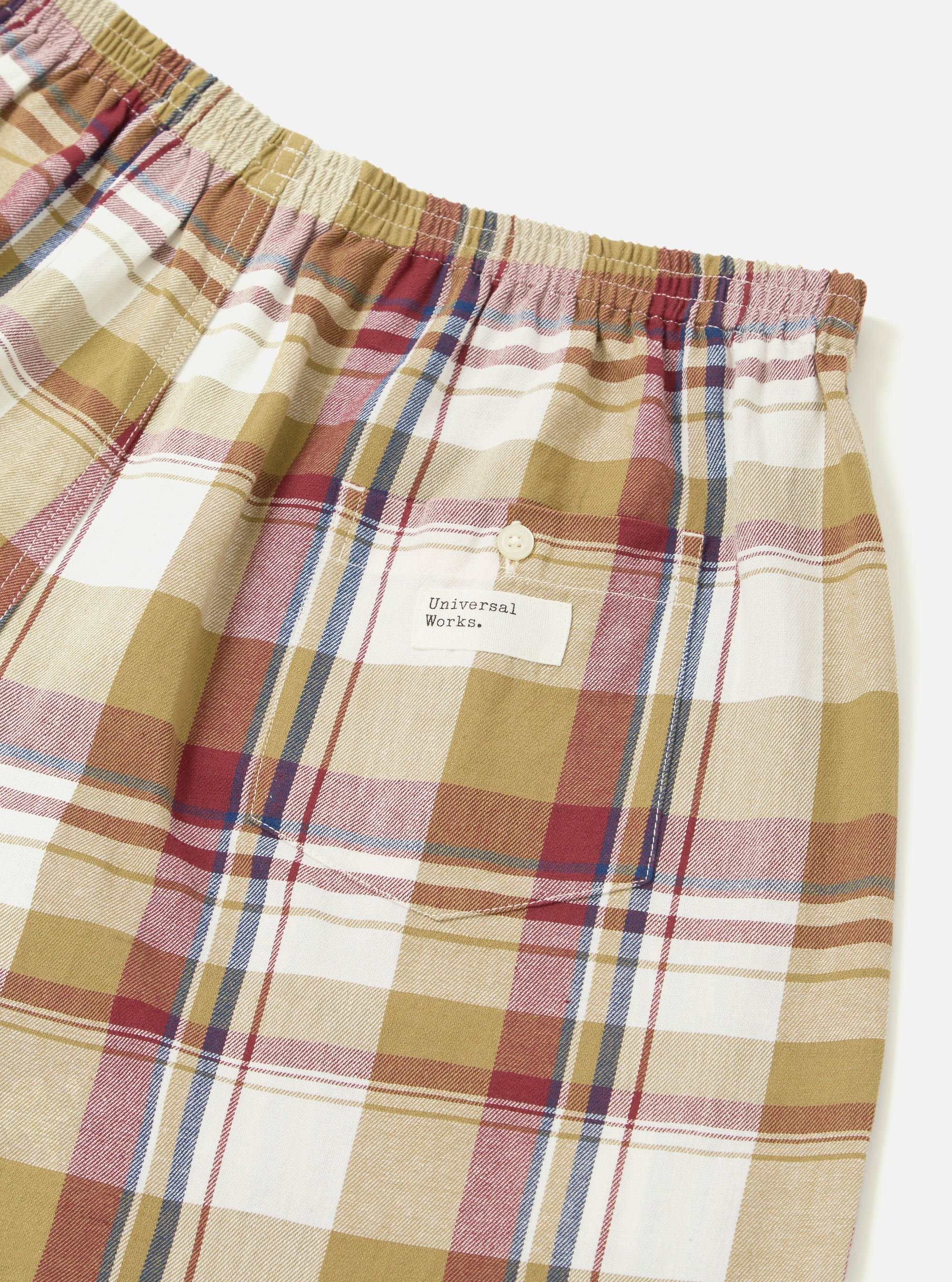 Close-up of Multi Kip Check 3 Pack Boxer Short. Cotton fabric with a colorful plaid pattern. Elastic waistband. Studio shot on a white background.