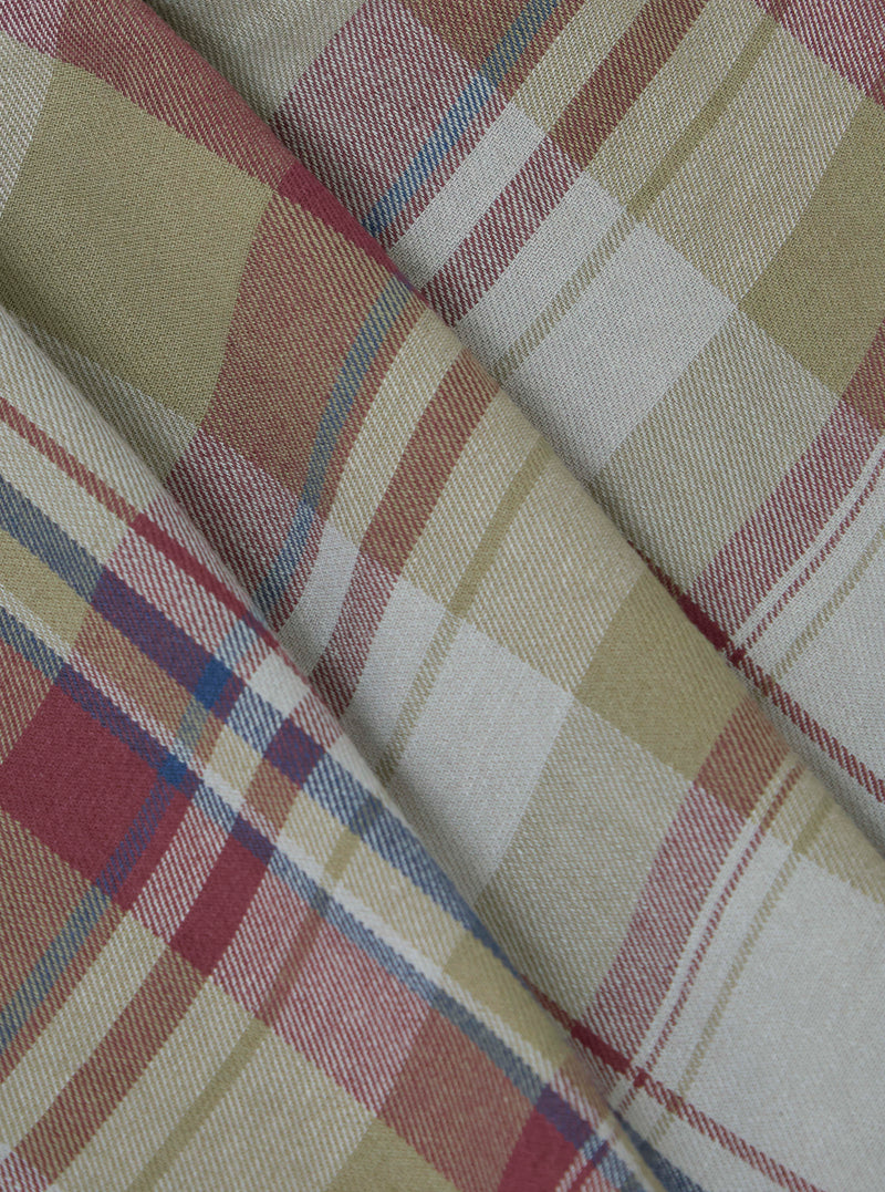 Close-up of folded Multi Kip Check 3 Pack Boxer Short fabric. Features a beige, red, and blue plaid pattern. The material is neatly arranged on a flat surface.