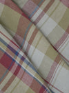 Close-up of folded Multi Kip Check 3 Pack Boxer Short fabric. Features a beige, red, and blue plaid pattern. The material is neatly arranged on a flat surface.