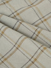 Close-up of the Multi PJ Plaid 3 Pack Boxer Short fabric. The material is a light beige with brown and gray plaid lines. The fabric is folded and textured.