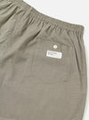 Close-up of the Green Tiny Check Boxer Short on a white background. The fabric has a small green and beige check pattern. Features an elastic waistband and a back pocket with a button.