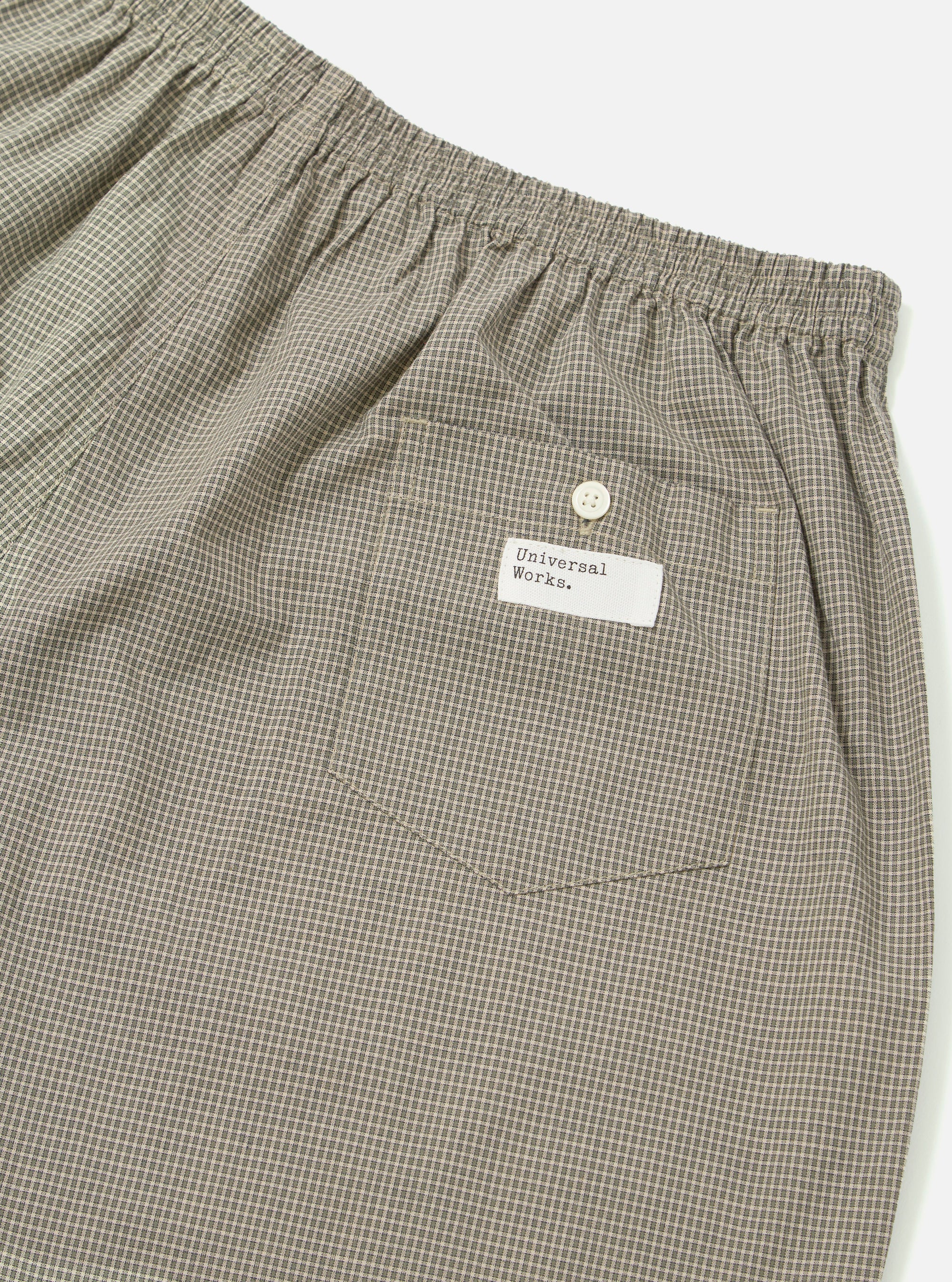 Close-up of the Green Tiny Check Boxer Short on a white background. The fabric has a small green and beige check pattern. Features an elastic waistband and a back pocket with a button.