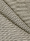 Close-up of the Green Tiny Check Boxer Short fabric. The material is a light beige with a small green check pattern. The fabric is folded on a plain surface.