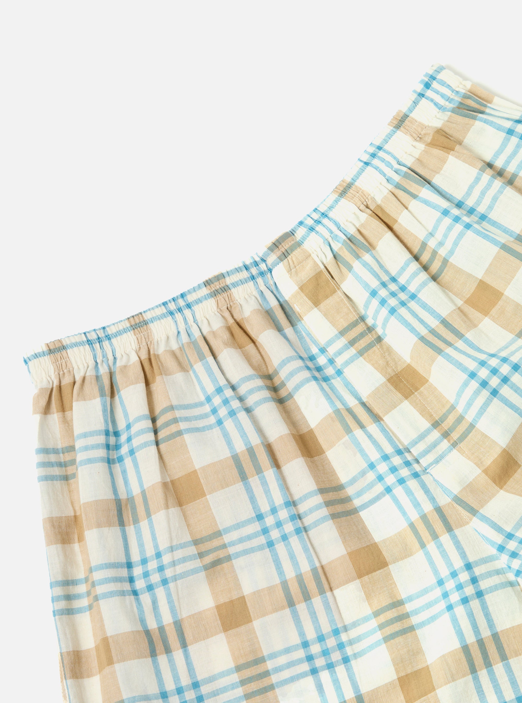 Close-up of Ecru Madras Check Boxer Short on a white background. The shorts feature a blue and tan plaid pattern and an elastic waistband.