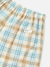 Close-up of the Ecru Madras Check Boxer Short on a white background. The fabric is a light plaid with ecru, tan, and blue lines. Features an elastic waistband and a small pocket.