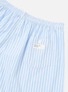 Close-up of the Blue Classic Stripe Boxer Short on a white background. The cotton boxer shorts have a pocket with a button and a 'Universal Works' tag.