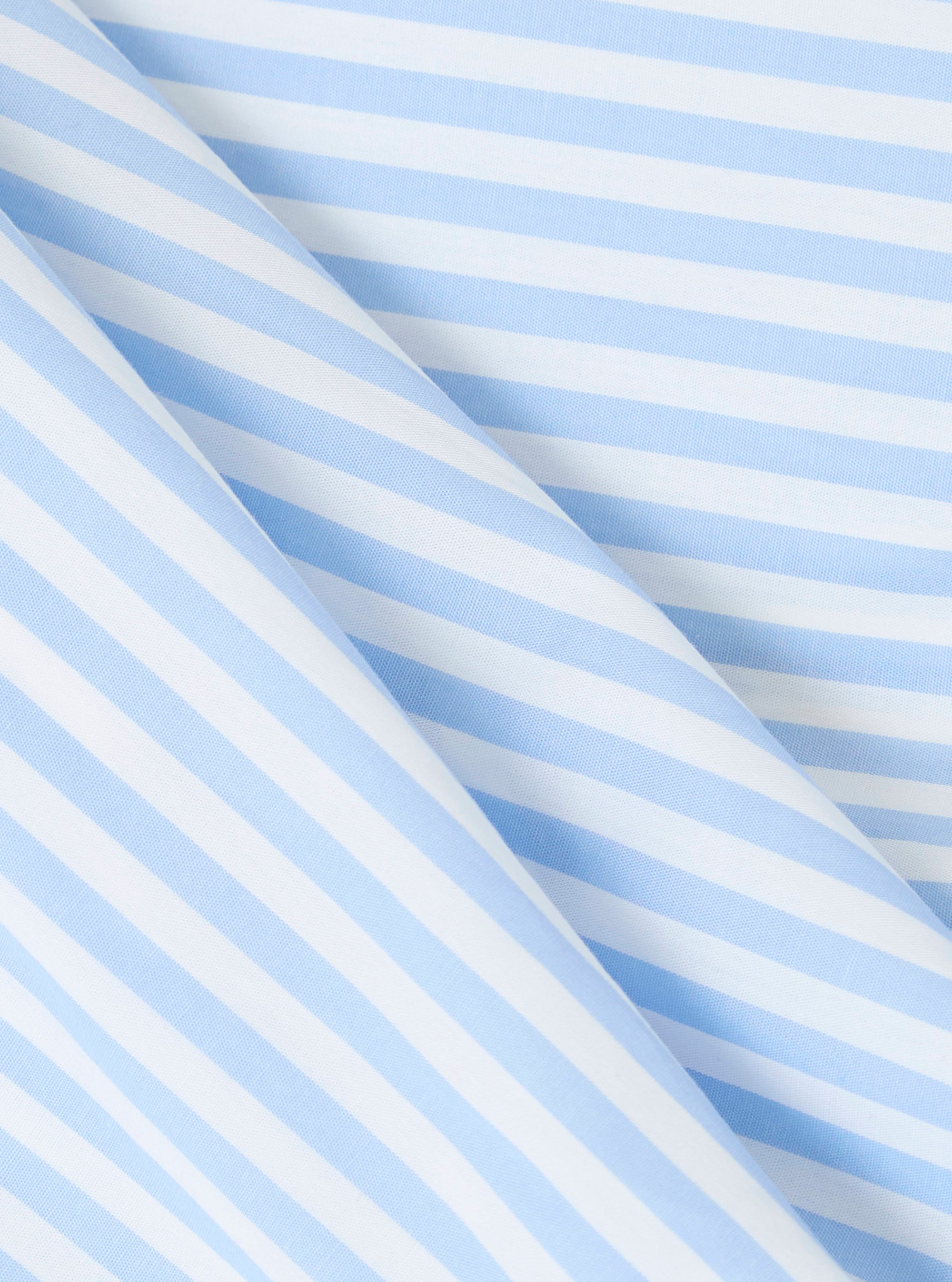 Close-up of the Blue Classic Stripe Boxer Short fabric. Features light blue and white stripes in a soft cotton blend. The material is folded on a white surface.