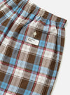 Close-up of the Blue/Brown Check 3 Boxer Short on a white surface. Features a brown, blue, pink, and white plaid pattern, elastic waistband, and a small pocket with a button.