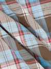 Close-up of the Blue/Brown Check 3 Long Pyjama Set fabric. The material is a soft, woven check pattern in blue, brown, pink and white. The fabric is draped to show texture.