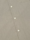 Close-up of the Green Tiny Check Long Pyjama Set, showing the fabric's small check pattern and white buttons. The background is a plain surface.