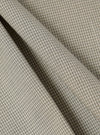 Close-up of the Green Tiny Check Long Pyjama Set fabric. Soft, green and white check pattern. Folded material on a plain surface.