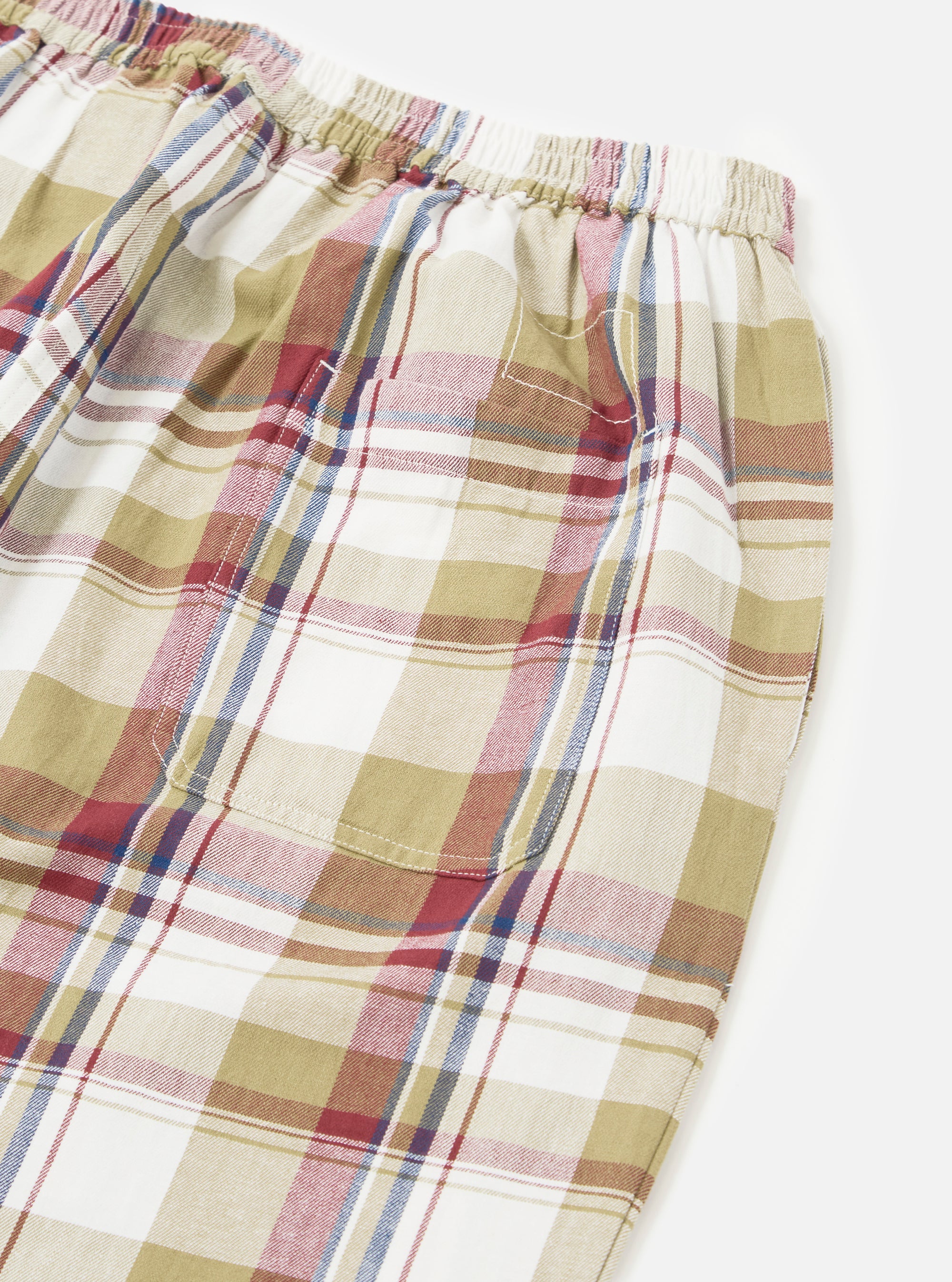 Close up of the Red/Brown Kip Check Long Pyjama Set. The cotton fabric features a red, brown, and white plaid pattern. The set is on a white background.