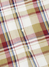 Close-up of the Red/Brown Kip Check Long Pyjama Set. The fabric is a soft, brushed cotton with a classic check pattern in red, brown, and white. Buttons are visible.