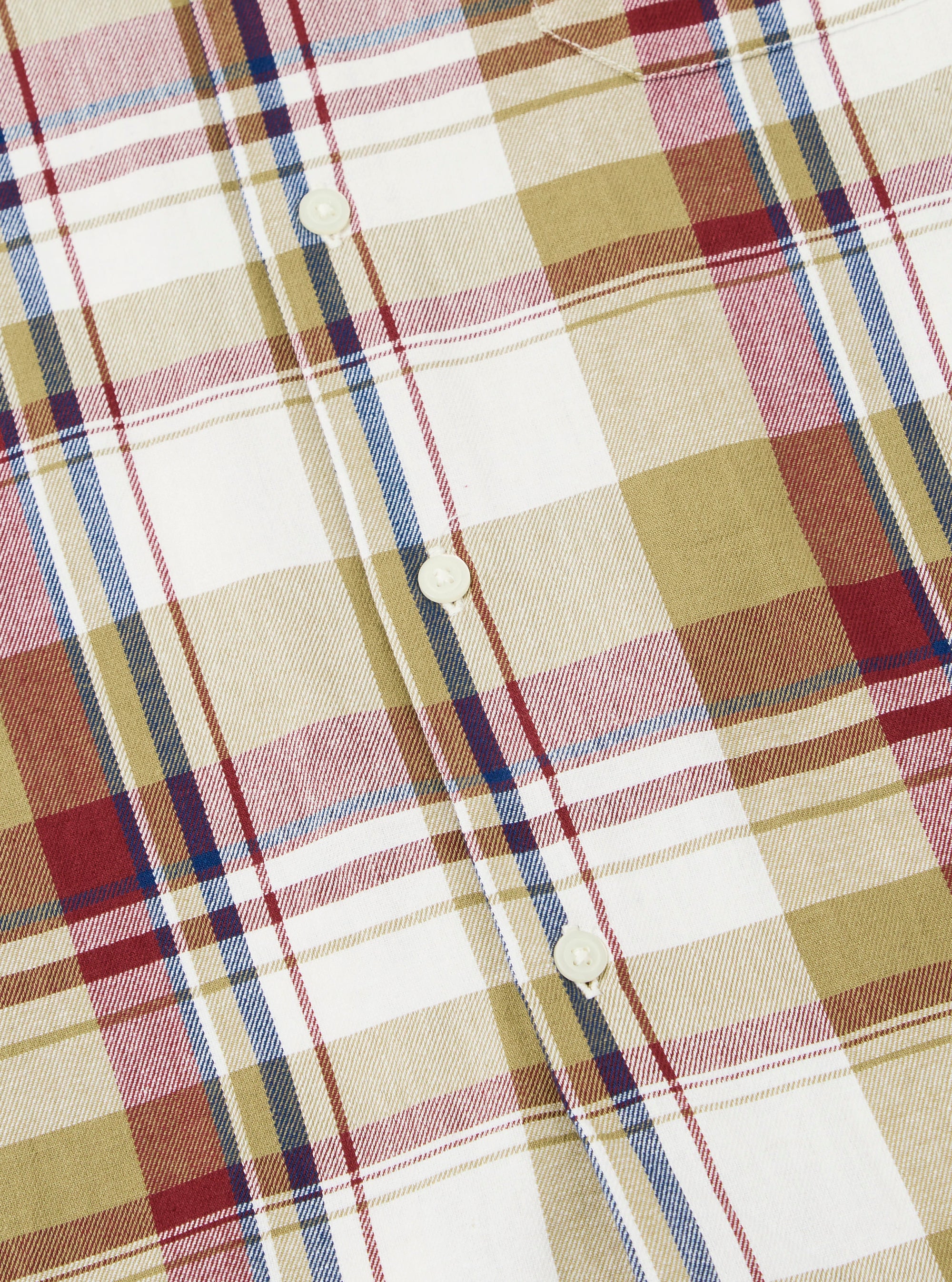 Close-up of the Red/Brown Kip Check Long Pyjama Set. The fabric is a soft, brushed cotton with a classic check pattern in red, brown, and white. Buttons are visible.