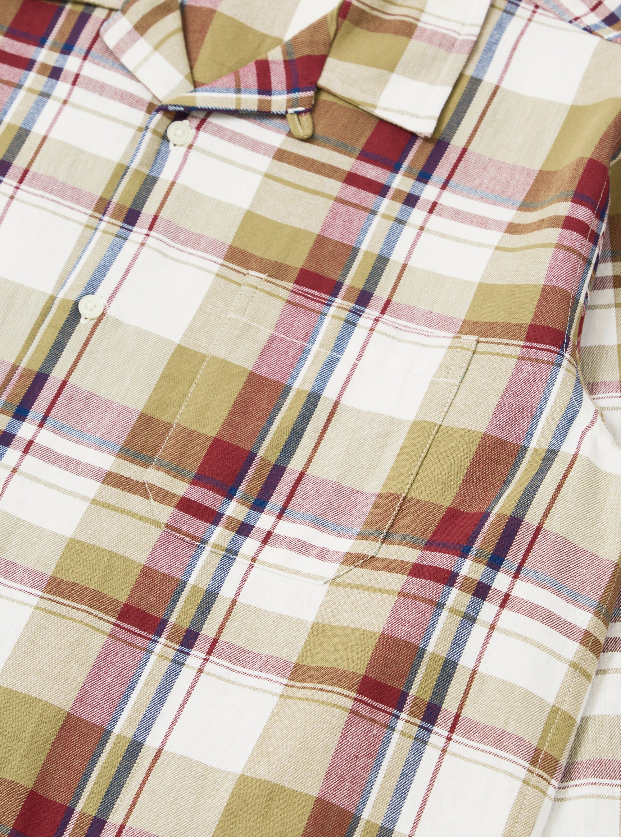Close-up of the Red/Brown Kip Check Long Pyjama Set. The fabric is a soft, brushed cotton with a classic check pattern. The set is neatly folded on a flat surface.