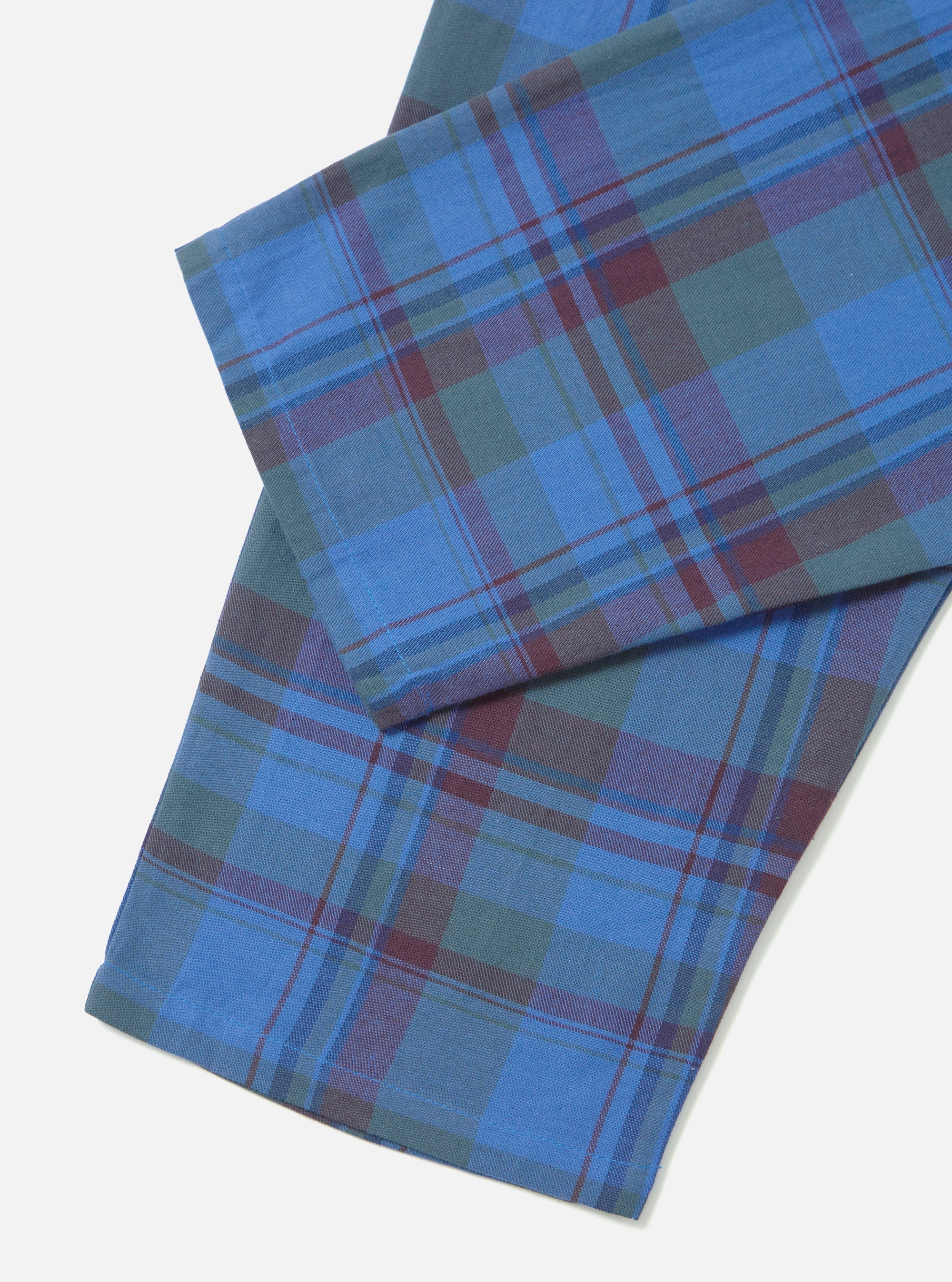 Close-up of the Blue Kip Check Long Pyjama Set. The fabric is a blue, green and burgundy plaid. Shot on a white background.
