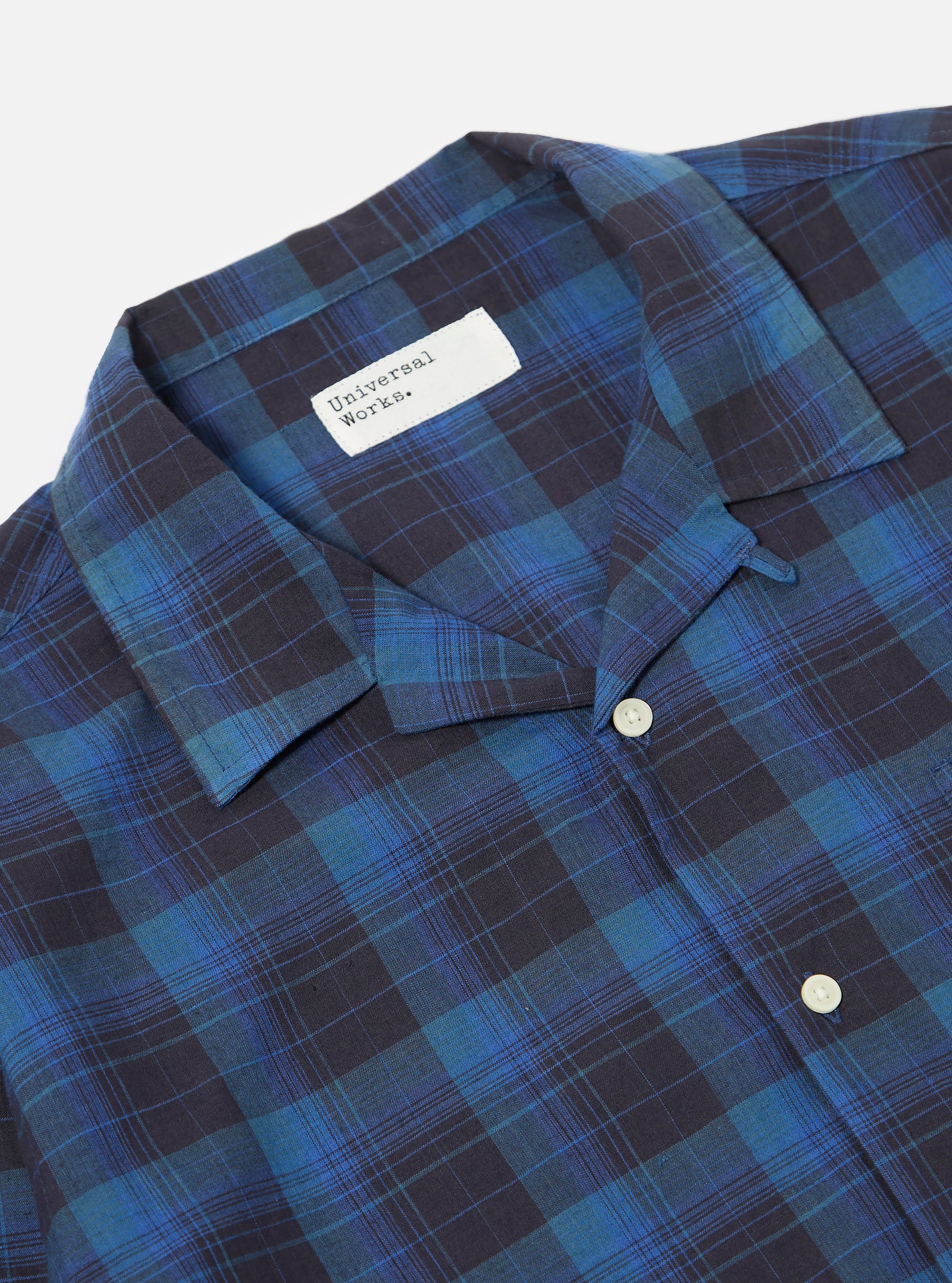 Close-up of the Navy/Blue Check Long Pyjama Set top. The shirt is neatly laid out on a white surface, showcasing its blue and navy plaid pattern and button-up design.