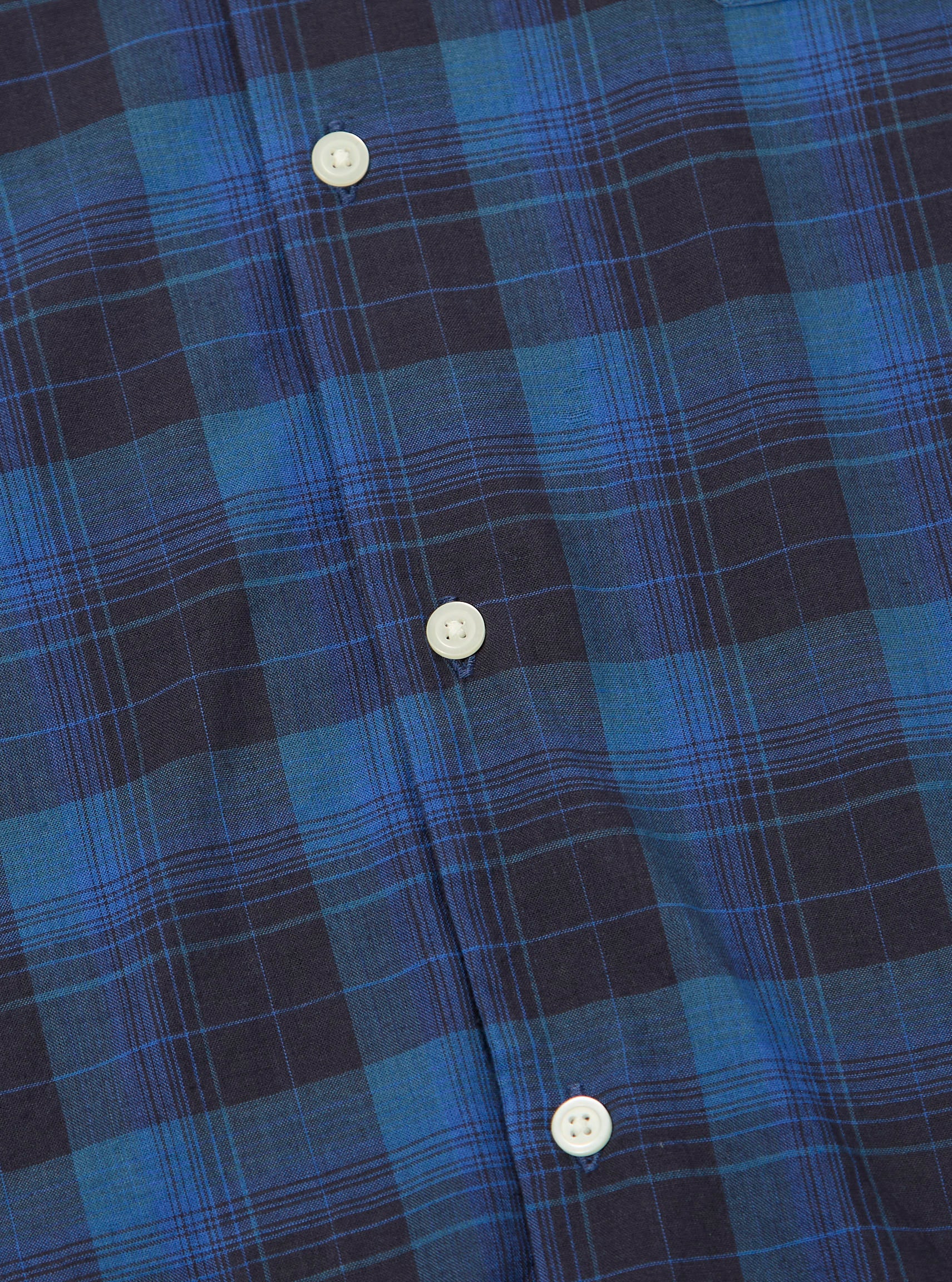 Close-up of the Navy/Blue Check Long Pyjama Set. The fabric is a soft-looking cotton blend with a classic check pattern. White buttons are visible. Shot on a flat surface.