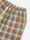 Close-up of the Yellow/Brown Check Short Pyjama Set. Features a yellow, brown, and blue plaid pattern. The shorts have an elastic waistband and a pocket. Shot on a white background.