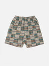 The Green Patchwork Madras Pyjama Short, featuring a green, brown, and white plaid pattern, is laid on a white background. The shorts have an elastic waistband.