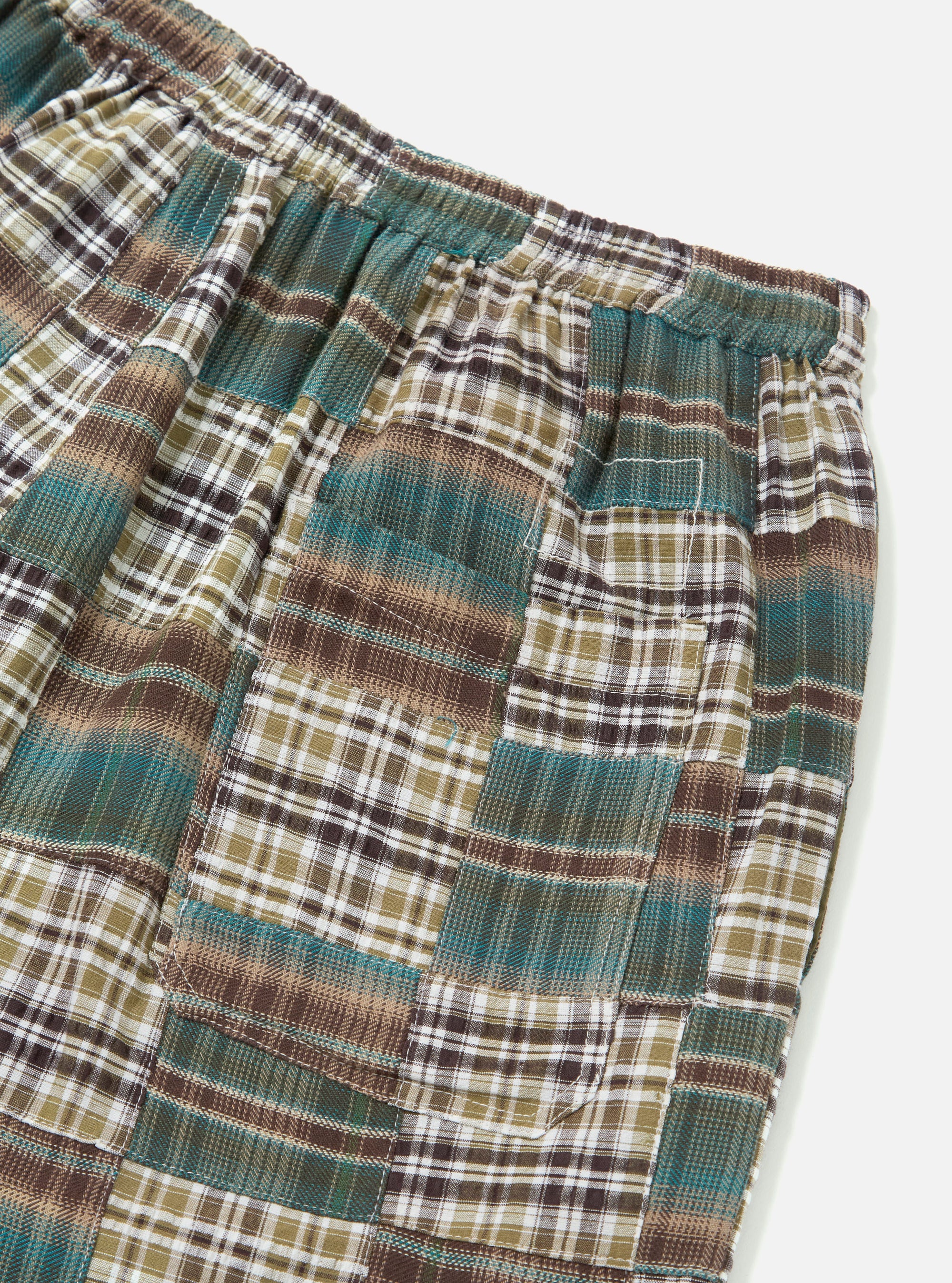 Close-up of the Green Patchwork Madras Pyjama Short on a white background. The shorts feature a patchwork design with green, brown, and white plaid patterns.