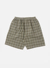 The Green PJ Plaid Pyjama Short, in a soft green and brown plaid pattern, is laid flat on a white background. The shorts have an elastic waist and a relaxed fit.