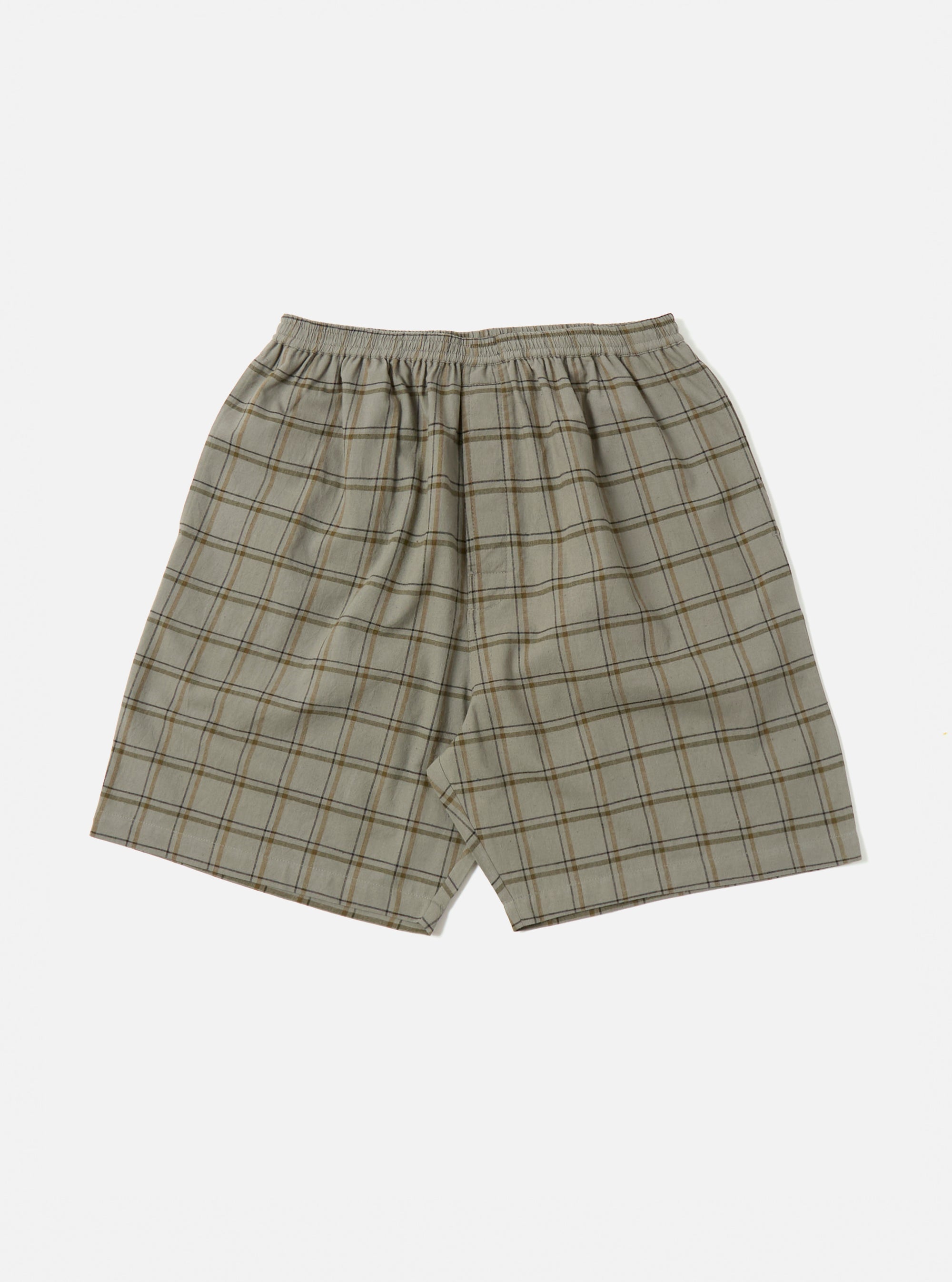 The Green PJ Plaid Pyjama Short, in a soft green and brown plaid pattern, is laid flat on a white background. The shorts have an elastic waist and a relaxed fit.
