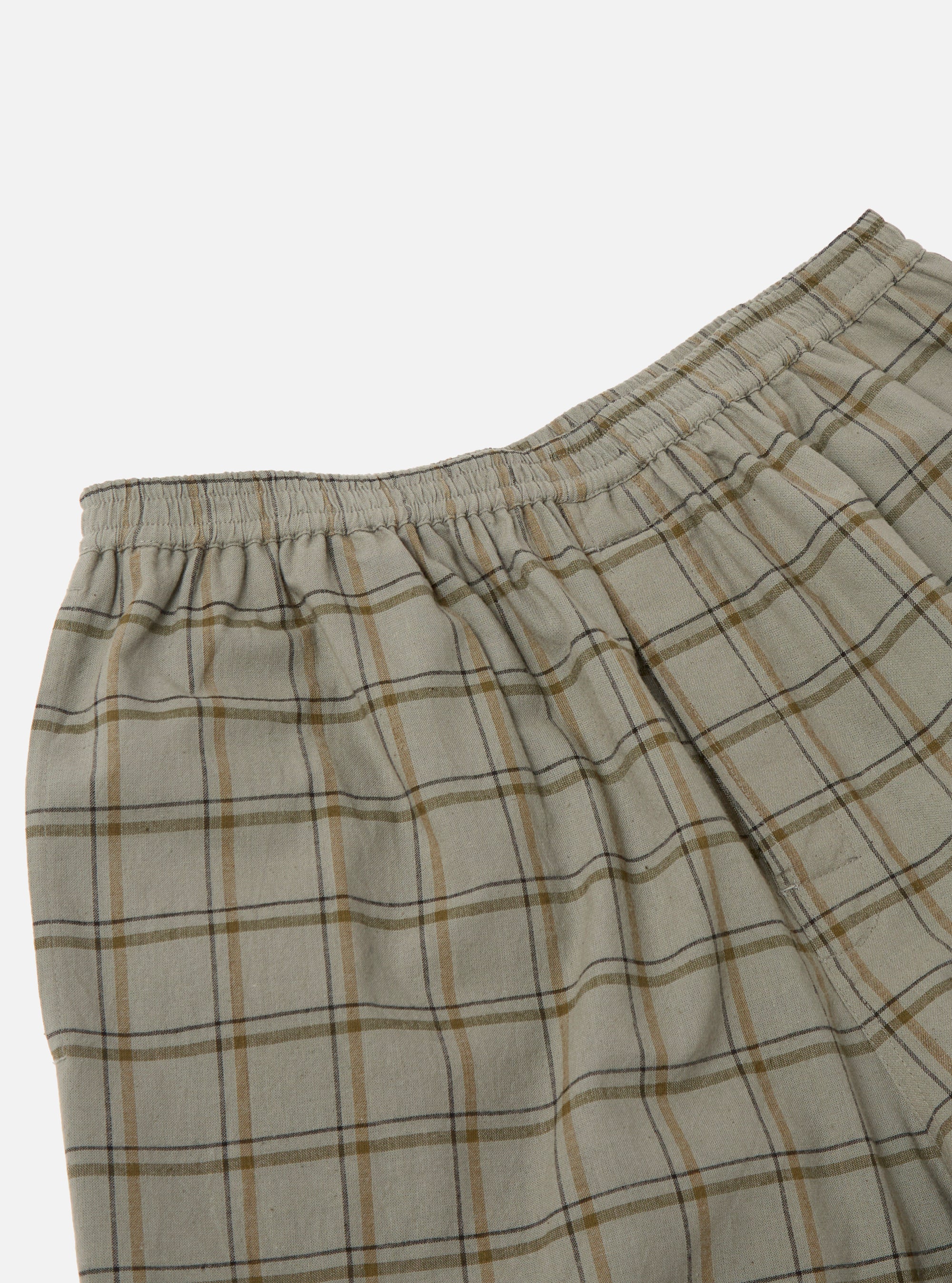 Close-up of the Green PJ Plaid Pyjama Short. The shorts feature a green and brown plaid pattern and an elastic waistband. Shot against a white background.