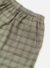 Close-up of the Green PJ Plaid Pyjama Short. The fabric is a soft, neutral plaid with brown and black lines. Elastic waistband and pocket are visible against a white background.
